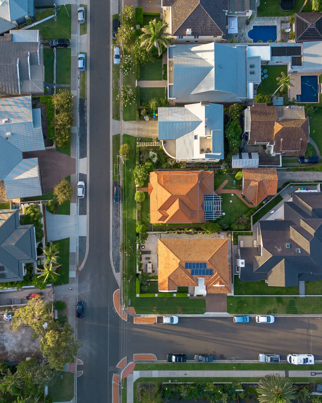Straight-down aerial of an Australian suburban street showing individual lots and driveways